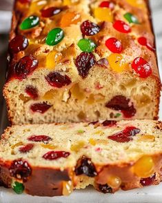 a loaf of fruity bread with jelly on top is cut in half and ready to be eaten