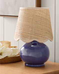 a blue lamp sitting on top of a wooden table