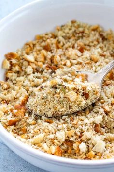 a white bowl filled with food and a spoon