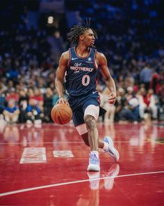 a basketball player dribbles the ball down the court