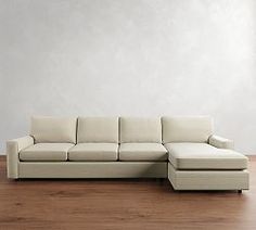 a white couch sitting on top of a wooden floor