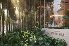 the entrance to an office building surrounded by palm trees