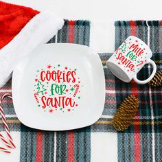 a white plate with cookies for santa on it next to a mug and candy canes