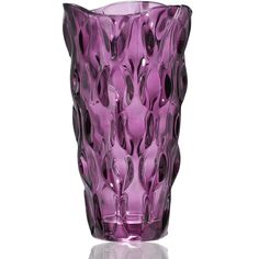 a purple glass vase sitting on top of a table