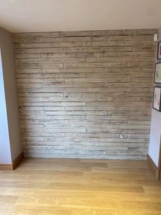 an empty room with wood flooring and a wall made out of boards that have been stacked together