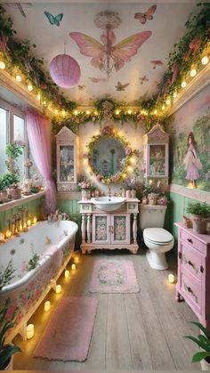 a bathroom decorated in pink and green with fairy lights