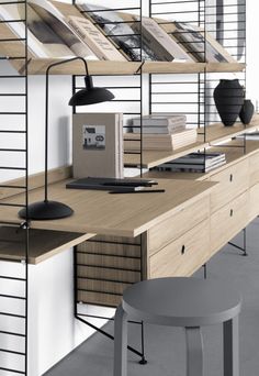 an office with shelves, desks and stools in it's center area