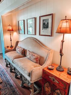 a living room filled with furniture and lamps