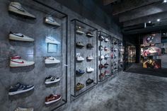 there are many pairs of shoes on display in the store's wall - to - wall display