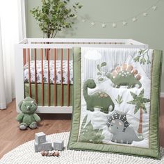 a baby crib bedding set with dinosaurs on it