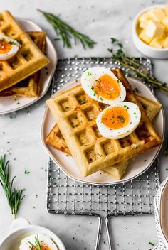 waffles and eggs on a plate with herbs