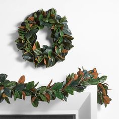 two wreaths are hanging on the wall next to each other, one is decorated with leaves