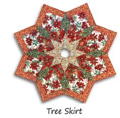 an orange and white quilted star with red flowers on it