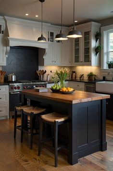 a kitchen island with two stools in front of it next to an oven and sink