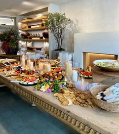 a table filled with food and candles on top of it