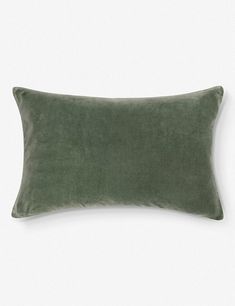 a green velvet pillow on a white background