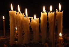 many candles are lit in the dark