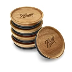 four wooden coasters with the word bud on them are stacked in front of each other