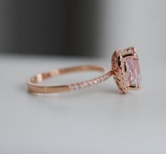 an engagement ring with a pink diamond in the center