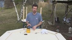 a man standing in front of a white table