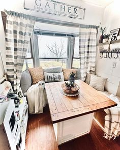 a kitchen with a wooden table in front of a window