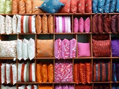 the shelves are filled with many different types of pillows