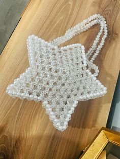 an ornament made out of beads on top of a wooden table