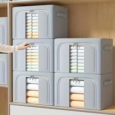 a woman is standing in front of several storage bins