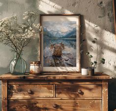 an old dresser with flowers and a painting on it