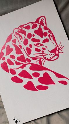 a red and white drawing of a cheetah sitting on top of a sheet