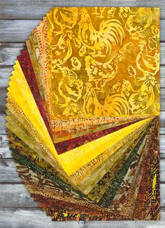 a pile of yellow and brown fabric on top of a wooden table