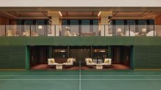 an indoor tennis court with chairs and tables