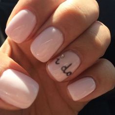 a woman's hand with pink and white nail polish