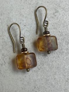 "small dangle earrings   golden brown czech glass earrings These small, rectangle Czech glass beads are matte golden yellow with a brown picasso coating - looking very much like tortoise shell. Each is topped with a small gold color glass disc and a tiny brown glass disc. Hook ear wires are antiqued brass. Length of earrings from top of ear wires is 1\". Rectangles measure 8x10mm. You can enter my shop here: gypsydangles.etsy.com" Small Handmade Earrings, Small Dangle Earrings, Glass Bead Earrings, Earrings Golden, Jewelry Accessories Ideas, Funky Jewelry, Fantasy Jewelry, Girly Jewelry, Glass Earrings