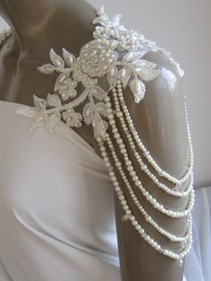 a white dress with pearls and beads on it