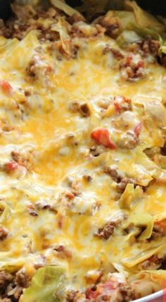 a casserole dish with meat, cheese and vegetables in it on a table