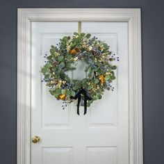 a white door with a wreath hanging on it