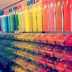 there are many different colored candies on display in the store's candy section