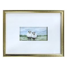 two sheep standing next to each other in a gold framed frame on a white wall