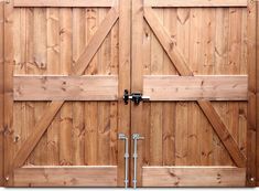 two wooden doors with metal latches on them