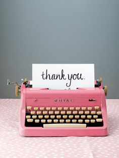 a pink typewriter with a thank you note on it