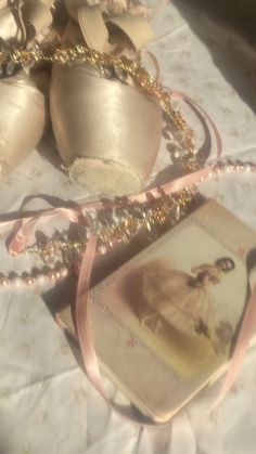 a pair of ballet shoes sitting on top of a table next to an ornament