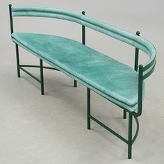 a green bench sitting on top of a white floor