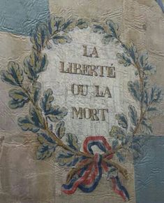 the words la libertte ou la mort are painted on an old brick wall