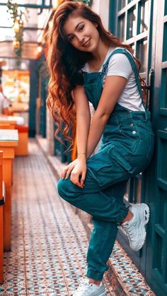 a woman leaning against the side of a building