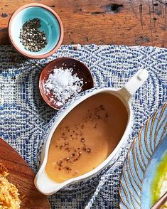 some food is laying out on a table with bowls and spoons next to it