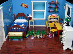 a toy bedroom with blue walls and wooden floors