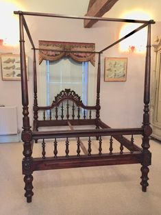 a wooden bed frame in a bedroom with white carpet