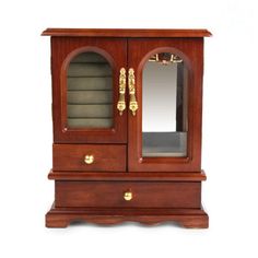 an antique wooden jewelry cabinet with mirrored doors