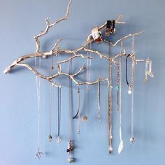 a tree branch with jewelry hanging from it